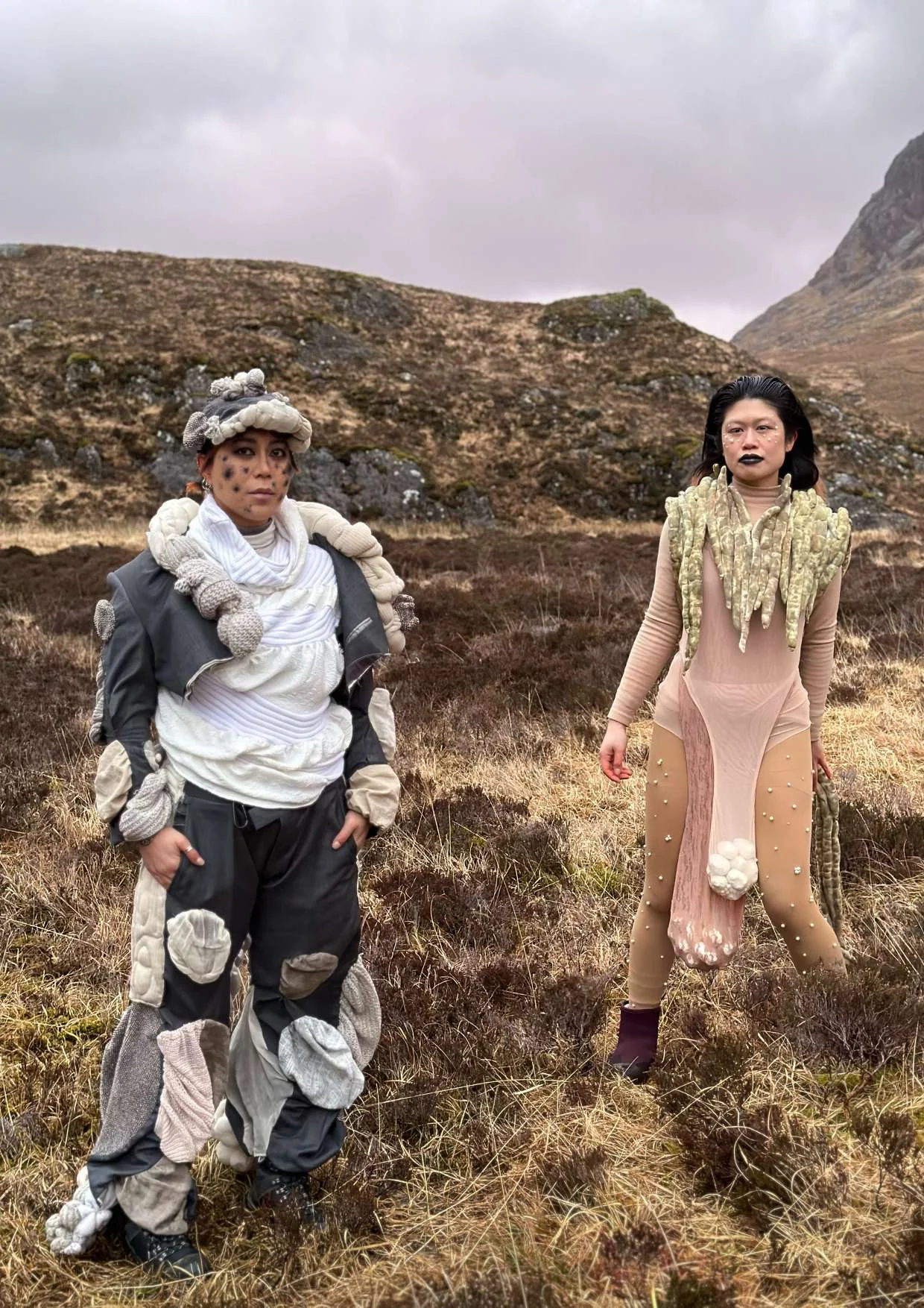 Two performers from Wah Yen standing in a Scottish landscape